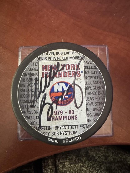 Can anyone please help me ID the player that signed this puck?