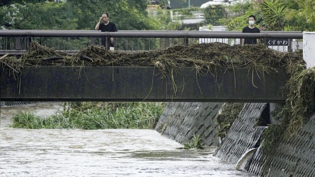 Slow tropical storm dumps heavy rain around Tokyo after causing floods in southern Japan