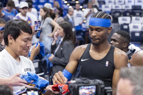 Oklahoma City Thunder guard Shai Gilgeous-Alexander signs his autograph for fans before game five of the western conference finals against the Minnesota Timberwolves for the 2025 NBA Playoffs at Paycom Center.