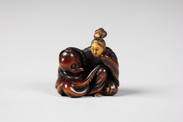 Carved wood and ivory Netsuke sculpture of a woman comforting an octopus, Japanese, c. 1800-1900. [4000x2667]