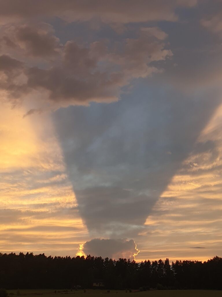 A small cloud casting a big shadow over the sky